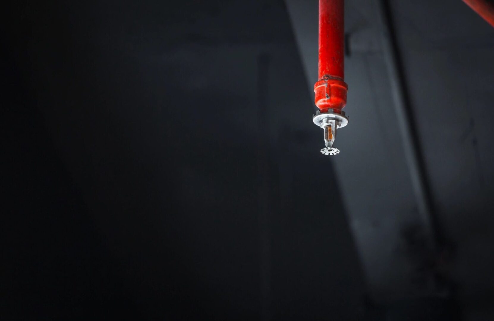 A red candle hanging from the ceiling of a room.