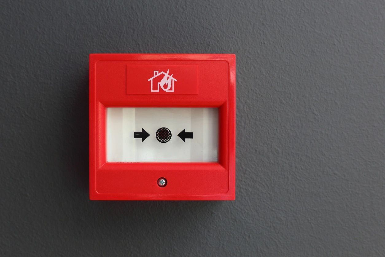 A red fire alarm on the wall