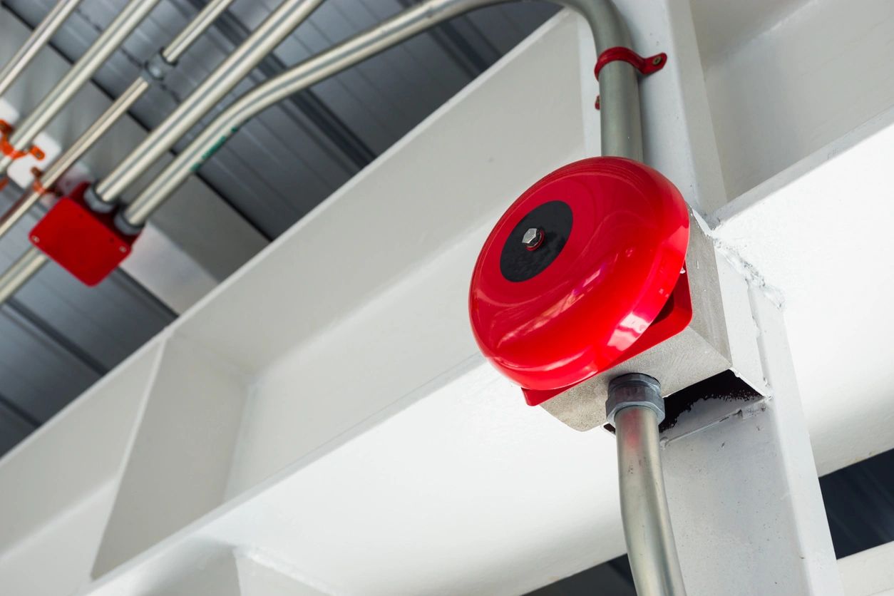 A red fire alarm on the side of a building.