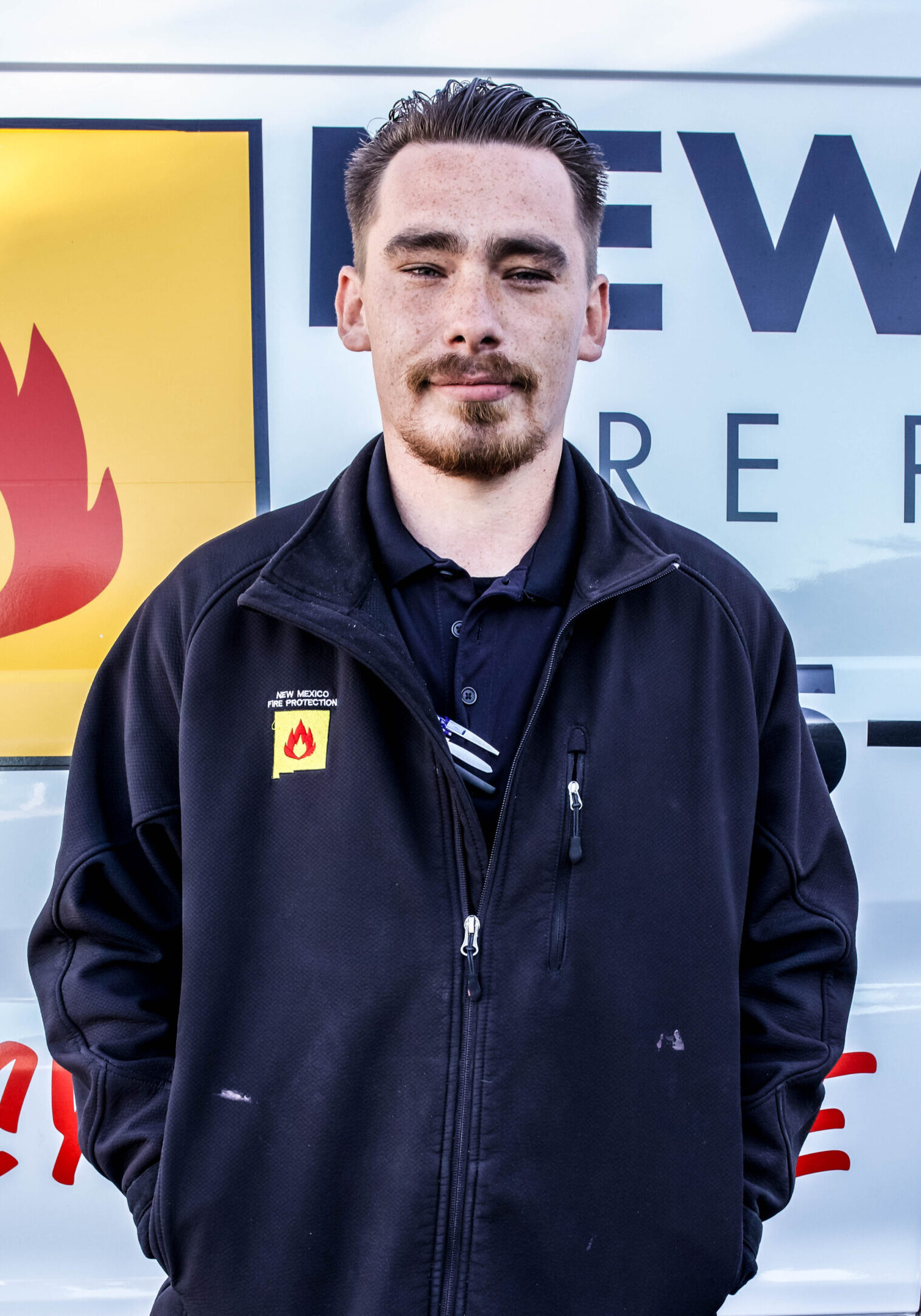 A man standing in front of a fire hydrant.